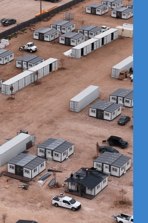 Aerial view of deployable BoxHouse units and shipping containers staged for rapid deployment